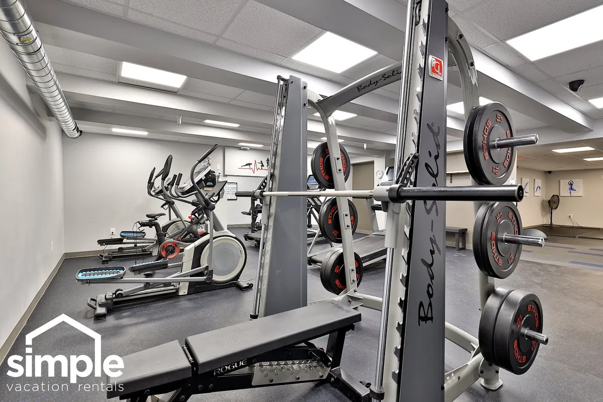A dynamic, motivational gym environment complete with weightlifting equipment, cardio machines, and an open space for movement. The setup suggests a modern and well-equipped fitness center ideal for various workout routines.
