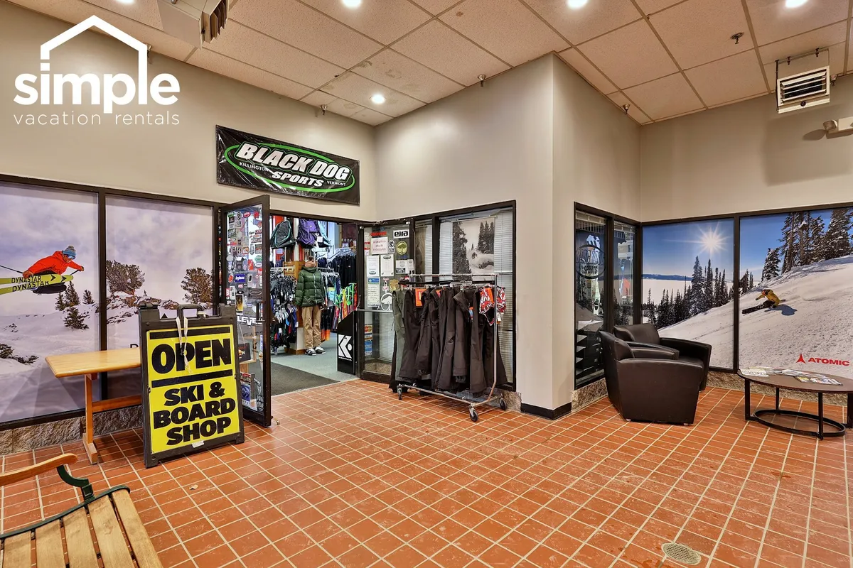 This interior image features the entrance to the onsite ski and board shop, with ski equipment displays and a comfortable seating area, creating an adventurous and inviting atmosphere for planning mountain activities.